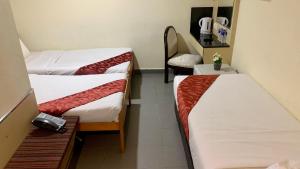 Letto o letti in una camera di Sandpiper Hotel Singapore