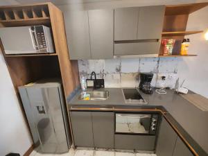 a small kitchen with a sink and a refrigerator at R2 - Moderno Loft en la historica Candelaria in Bogotá