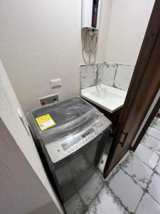a dirty bathroom with a sink and a toilet at R2 - Moderno Loft en la historica Candelaria in Bogotá