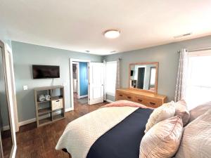 a bedroom with a bed and a tv on the wall at The Absolute Best Home Away From Home Pet Friendly!!! in Wilmington