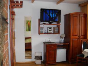 a living room with a tv on a wall at Ośrodek Wypoczynkowo - Szkoleniowy Bogdanka in Przybrodzin