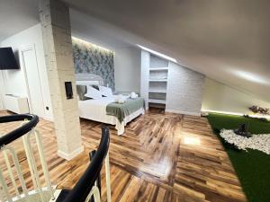 a large room with a bed and a staircase at Plaza Mayor Salamanca in Salamanca