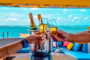 two people holding up glasses of champagne at Hotel Aracaju Suites in Aracaju