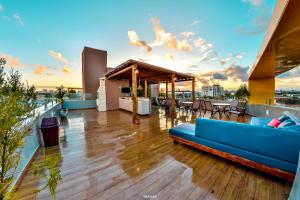 a blue couch sitting on a deck on a building at Hotel Aracaju Suites in Aracaju