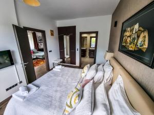 a bedroom with two beds with white pillows at Silver Mountain G1 39 Perfect For You in Poiana Brasov