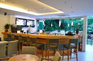 un bar dans un restaurant avec des chaises et des tables dans l'établissement Corfu Mare Hotel -Adults only, à Corfou