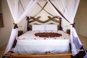 A bed or beds in a room at Uroa Zanzibar Vera Beach Hotel by Moonshine