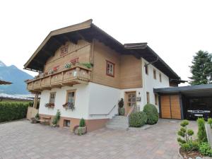 a large house with a balcony and a patio at Boutique - Apartments Tauernblick in Walchen