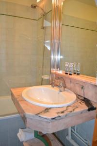 a bathroom with a sink and a glass shower at Résidence Montana Premier in Val Thorens