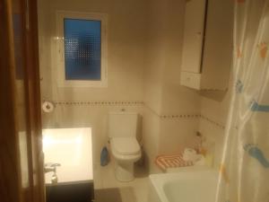 ein kleines Badezimmer mit Toilette und Waschbecken in der Unterkunft Piso entero cerca de Valencia y sus playas. in Albalat dels Sorells + 3 Fotos