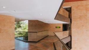a staircase in a building with a large window at Travelers Rio Verde Living Suites in Rionegro