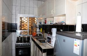 a kitchen with a stove and a counter top at ENJOY n RELAX in Douala