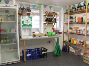 a shop with a counter and shelves with products at Lime Kiln in Blagdon