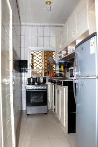 a kitchen with a stove and a refrigerator at ENJOY n RELAX in Douala