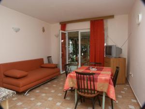 a living room with a couch and a table at Apartments by the sea Crikvenica - 2354 in Crikvenica