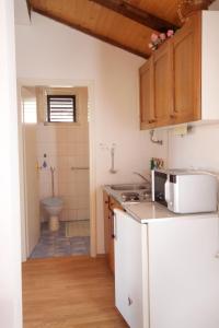 a kitchen with a sink and a toilet in a bathroom at Apartments by the sea Selce, Crikvenica - 2372 in Selce