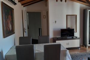 a living room with a table and a television at Apartments by the sea Selce, Crikvenica - 2372 in Selce