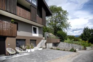 a building with two chairs sitting outside of it at Apartment Peskoller in Falzes