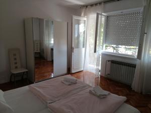 a bedroom with a bed and a large mirror at Apartment Selce 2381d in Selce