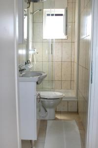 a bathroom with a toilet and a sink and a tub at Double Room Novi Vinodolski 2350a in Novi Vinodolski