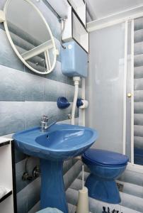 a bathroom with a blue sink and a mirror at Apartments and rooms with parking space Novi Vinodolski - 2350 in Novi Vinodolski
