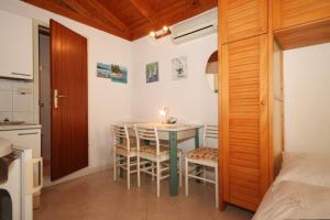 a small kitchen with a table and chairs in a room at Apartments with a parking space Opatija - Volosko, Opatija - 2349 in Volosko