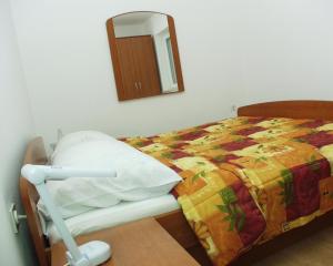 a hospital room with a bed and a mirror at Apartment Rabac 2323a in Rabac