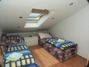 a attic room with two beds and a skylight at Apartment Crikvenica 2354e in Crikvenica