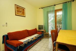 a living room with a couch and a table at Apartments with a parking space Povile, Novi Vinodolski - 2398 in Povile