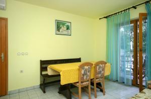 a dining room with a yellow table and chairs at Apartments with a parking space Povile, Novi Vinodolski - 2398 in Povile