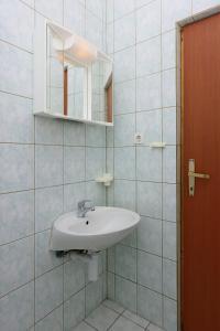 a bathroom with a sink and a mirror at Twin Room Selce 2362a in Selce