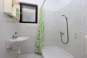 a bathroom with a sink and a shower at Triple Room Selce 2362c in Selce