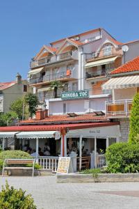 a hotel building with a restaurant in front of it at Studio Selce 2364a in Selce