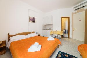 a bedroom with a large bed with two towels on it at Studio Selce 2364a in Selce