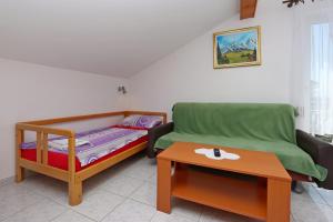 a small room with a bed and a table at Apartment Selce 2362a in Selce