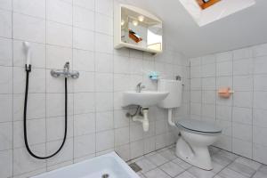 a bathroom with a shower and a toilet and a sink at Apartment Selce 2362a in Selce