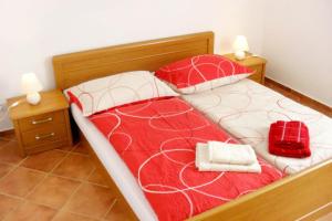 a bed with two towels and a red bag on it at Apartments with a parking space Valbandon, Fazana - 2310 in Fondole