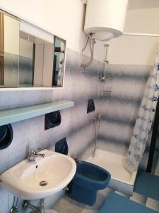 a bathroom with a sink and a mirror and a toilet at Apartment Selce 2381a in Selce