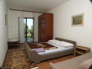 a bedroom with a bed and a couch in it at Apartments and rooms with parking space Dramalj, Crikvenica - 2386 in Dramalj