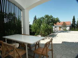 a white table and chairs on a patio at Apartments and rooms with parking space Dramalj, Crikvenica - 2386 in Dramalj