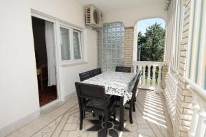 a table and chairs on the balcony of a house at Apartments by the sea Selce, Crikvenica - 2392 in Selce