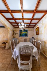 a dining room with a table and chairs and a chandelier at Villa Osiris in Flic-en-Flac