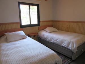 Postel nebo postele na pokoji v ubytování Cabañas El Roble Lican Ray