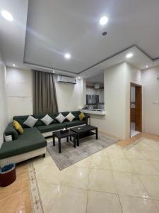 a living room with a couch and a table at ترند سويتس - TREND Suites in Al Baha