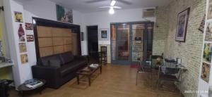 a living room with a couch and a table and chairs at Casa Rosário Centro de Amparo in Amparo
