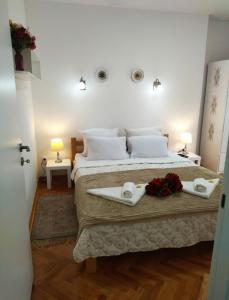 a bedroom with a large bed with two towels on it at Palace Luxury Apartments The Heart of Belgrade in Belgrade