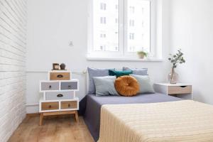 Posteľ alebo postele v izbe v ubytovaní Roomsy Świętojańska