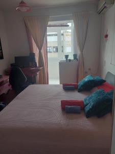 a bedroom with a bed with three pillows on it at Vita apartments in Zagreb +1 photo