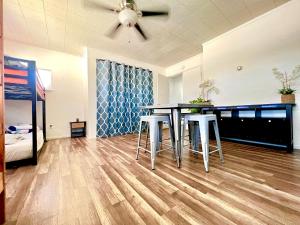 a kitchen with a table and stools in a room at WHOLE Family - Rosemont in Sacramento