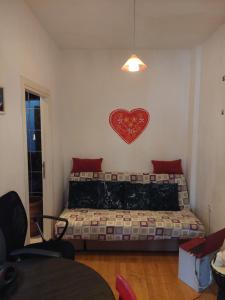a bedroom with a bed with a heart on the wall at Vita apartments in Zagreb